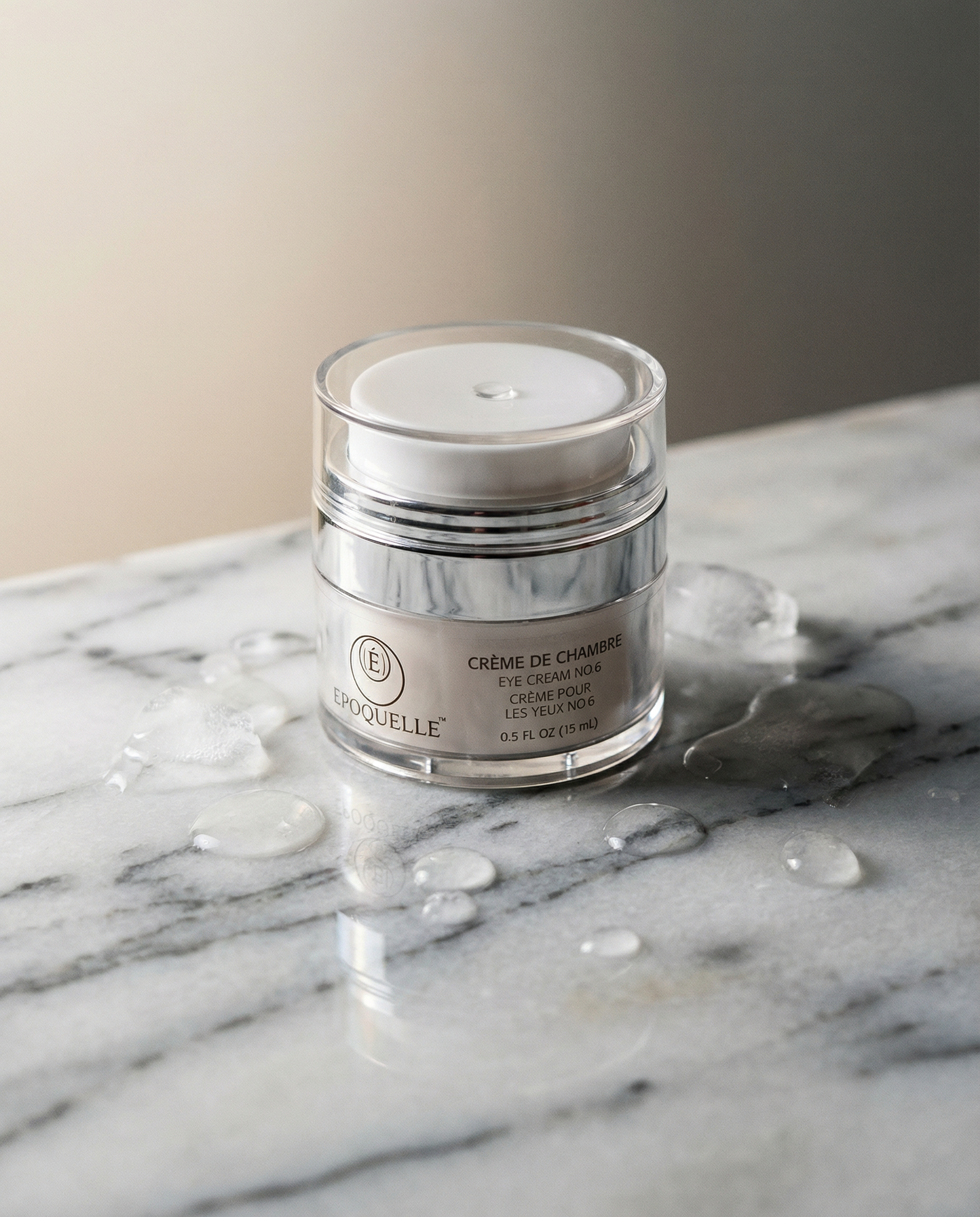 Époquelle Crème de Chambre eye cream jar on marble surface with water droplets